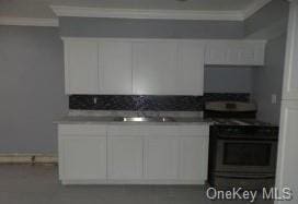 kitchen with black stove, white cabinetry, and ornamental molding