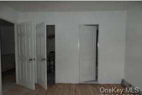 unfurnished bedroom with hardwood / wood-style flooring