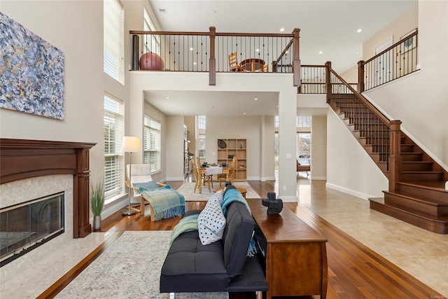 living room featuring a towering ceiling and wood-type flooring