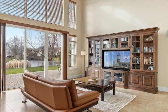 living room featuring light tile patterned floors and a high ceiling