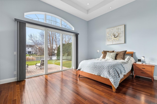 bedroom featuring access to exterior and hardwood / wood-style flooring