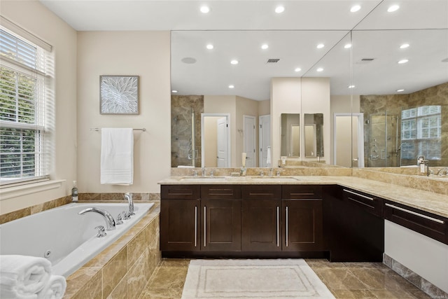 bathroom featuring vanity and separate shower and tub