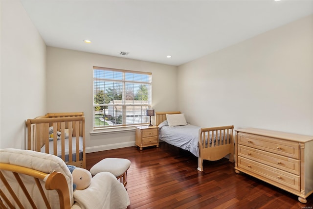 bedroom with dark wood-type flooring