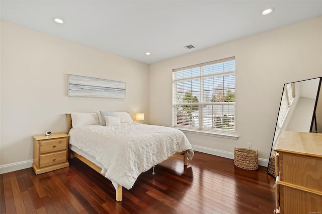 bedroom with dark hardwood / wood-style floors