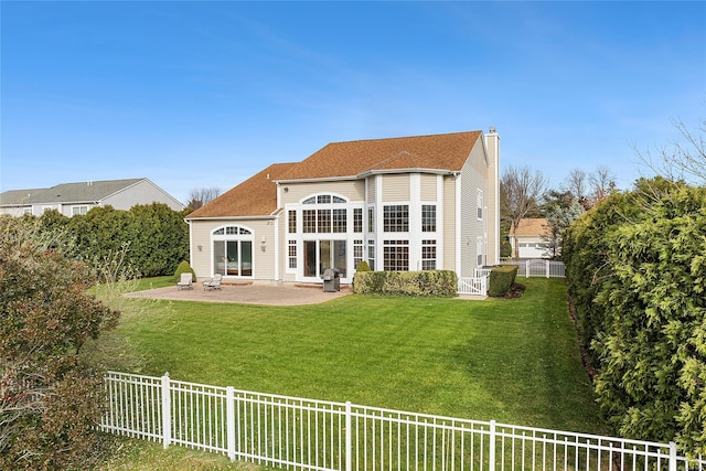 rear view of house featuring a patio area and a yard