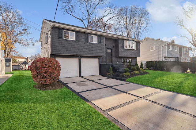 raised ranch featuring a front lawn and a garage