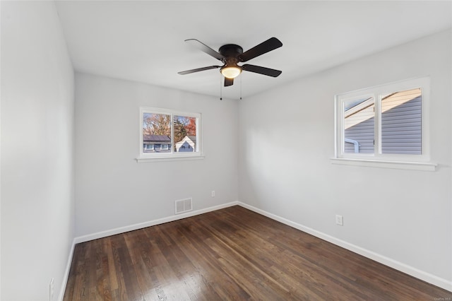 spare room featuring ceiling fan and dark wood-type flooring