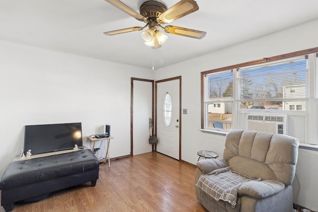 sitting room with hardwood / wood-style flooring and ceiling fan