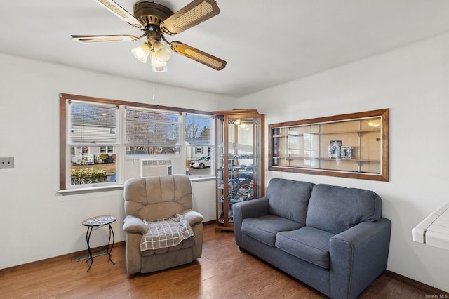 living room with wood-type flooring, cooling unit, and ceiling fan