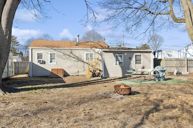 rear view of house featuring an outdoor fire pit