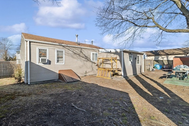 back of house with an outbuilding