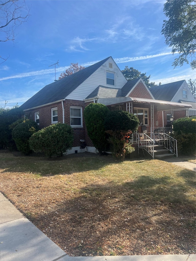 view of front of house with a front yard and covered porch