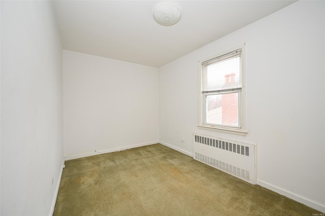 carpeted spare room with radiator