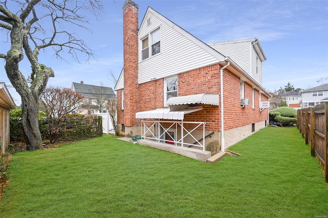 rear view of house featuring a yard and cooling unit