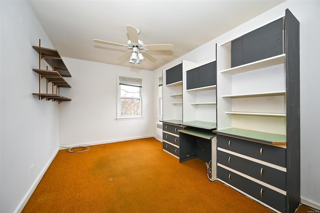 unfurnished office featuring carpet, radiator, and ceiling fan