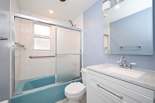 full bathroom featuring shower / bath combination with glass door, vanity, and toilet