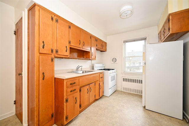 kitchen with white appliances, sink, and radiator