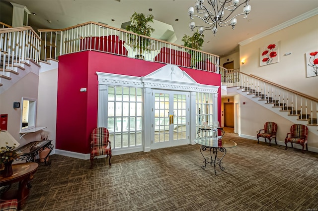 811 Spring Lake Dr Unit 811, Middle Island, NY 11953 - carpeted foyer entrance with a towering ceiling, stairs, crown molding, a chandelier, and french doors
