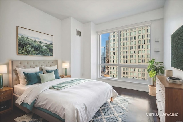 bedroom with dark hardwood / wood-style floors