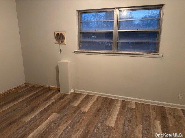 unfurnished room featuring dark wood-type flooring