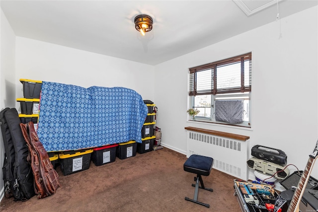 exercise area featuring carpet and radiator heating unit