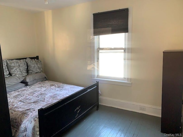 bedroom with dark hardwood / wood-style floors