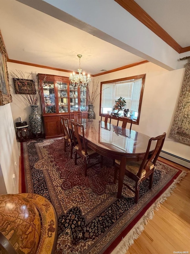 dining space featuring a baseboard heating unit, a chandelier, hardwood / wood-style flooring, and ornamental molding