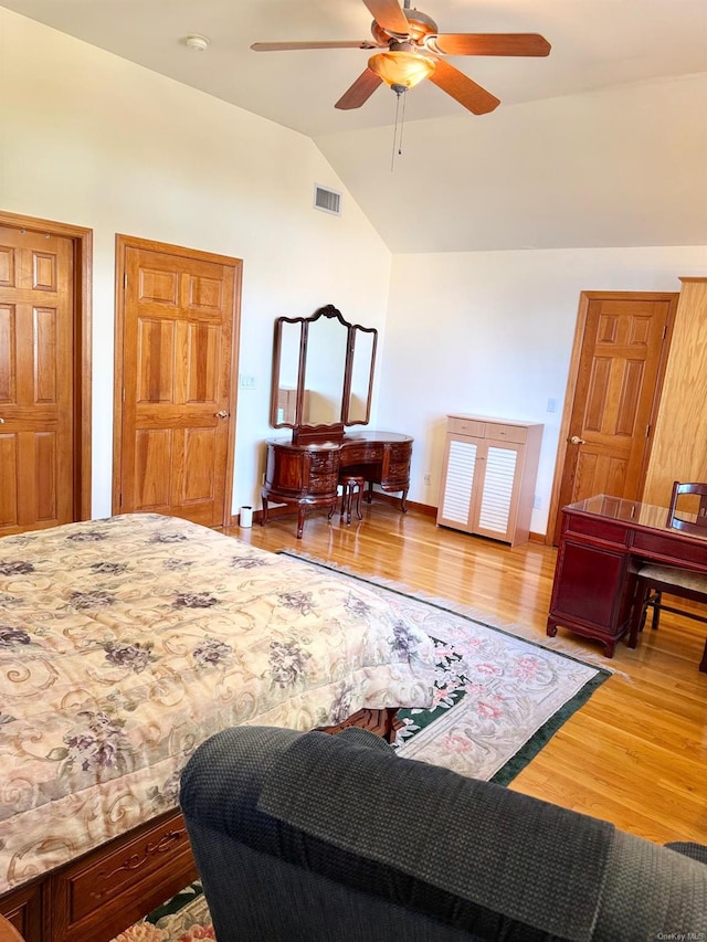 bedroom featuring lofted ceiling, wood-type flooring, and ceiling fan