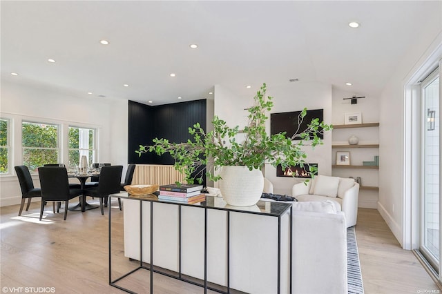 living room with vaulted ceiling and light hardwood / wood-style flooring