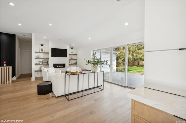 living room with light hardwood / wood-style flooring and lofted ceiling