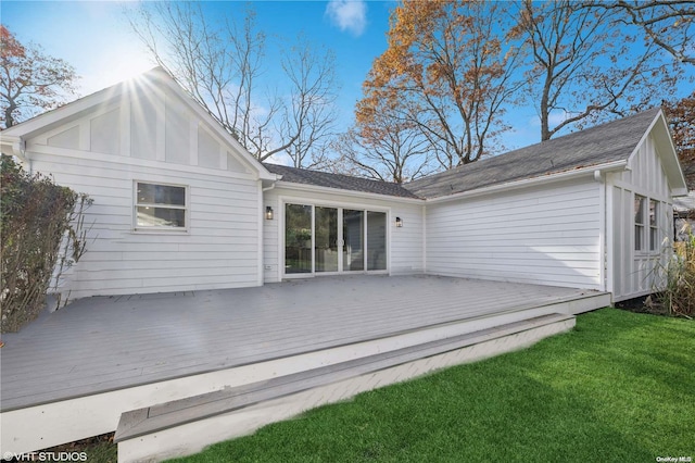 rear view of house featuring a lawn and a wooden deck