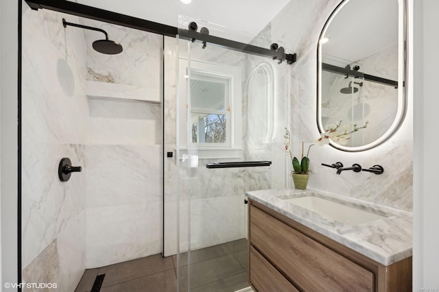 bathroom featuring tile patterned floors, vanity, and walk in shower