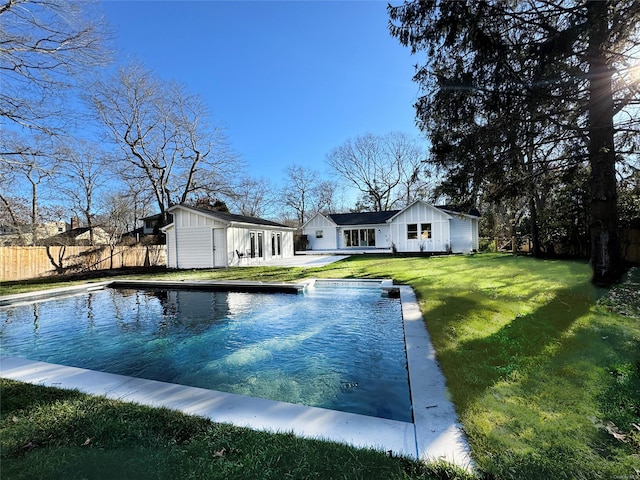 view of pool featuring an outbuilding and a lawn