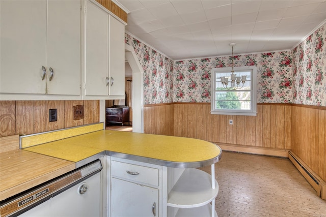 kitchen with an inviting chandelier, white dishwasher, a baseboard radiator, decorative light fixtures, and white cabinetry