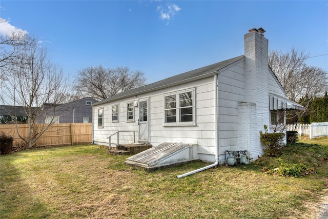 back of property featuring a lawn