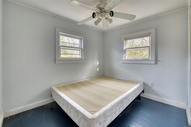 unfurnished bedroom featuring multiple windows, ceiling fan, and crown molding