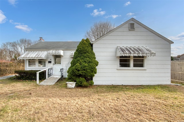 back of house with a yard