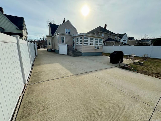 view of home's exterior with cooling unit and a patio area