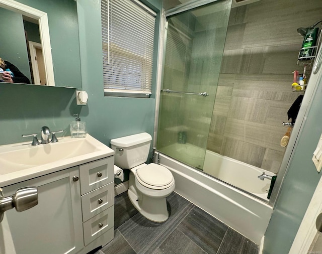 full bathroom with vanity, toilet, and bath / shower combo with glass door