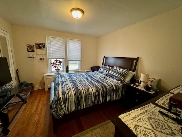 bedroom with dark hardwood / wood-style flooring