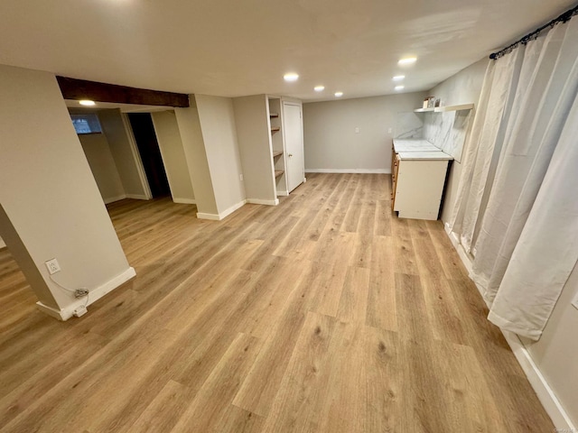 basement featuring light hardwood / wood-style flooring