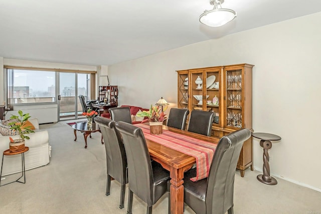 dining space with light colored carpet