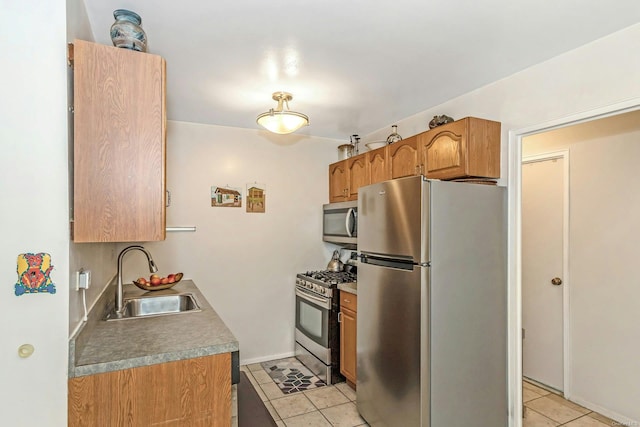 kitchen with sink, light tile patterned floors, and stainless steel appliances