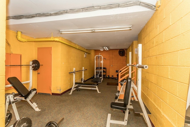 exercise room with dark colored carpet