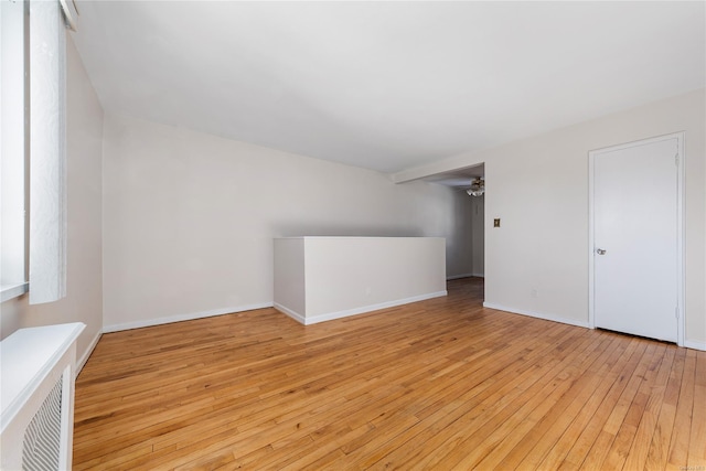 unfurnished room with ceiling fan and light wood-type flooring