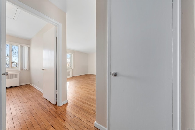 hall with radiator and light hardwood / wood-style floors