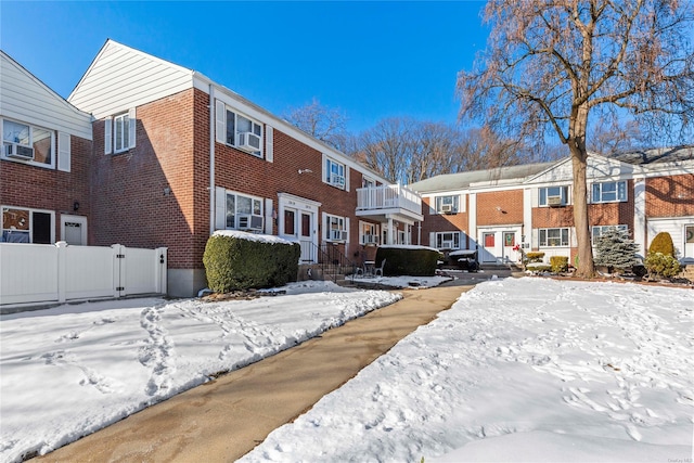 view of snow covered back of property