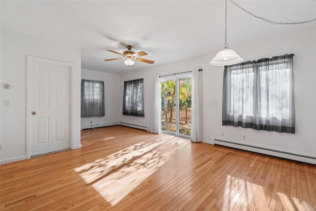 unfurnished room featuring ceiling fan, light hardwood / wood-style floors, and a baseboard radiator