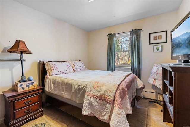 bedroom featuring light tile patterned floors and baseboard heating