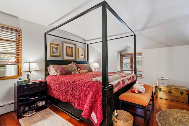 bedroom featuring wood-type flooring, baseboard heating, and multiple windows